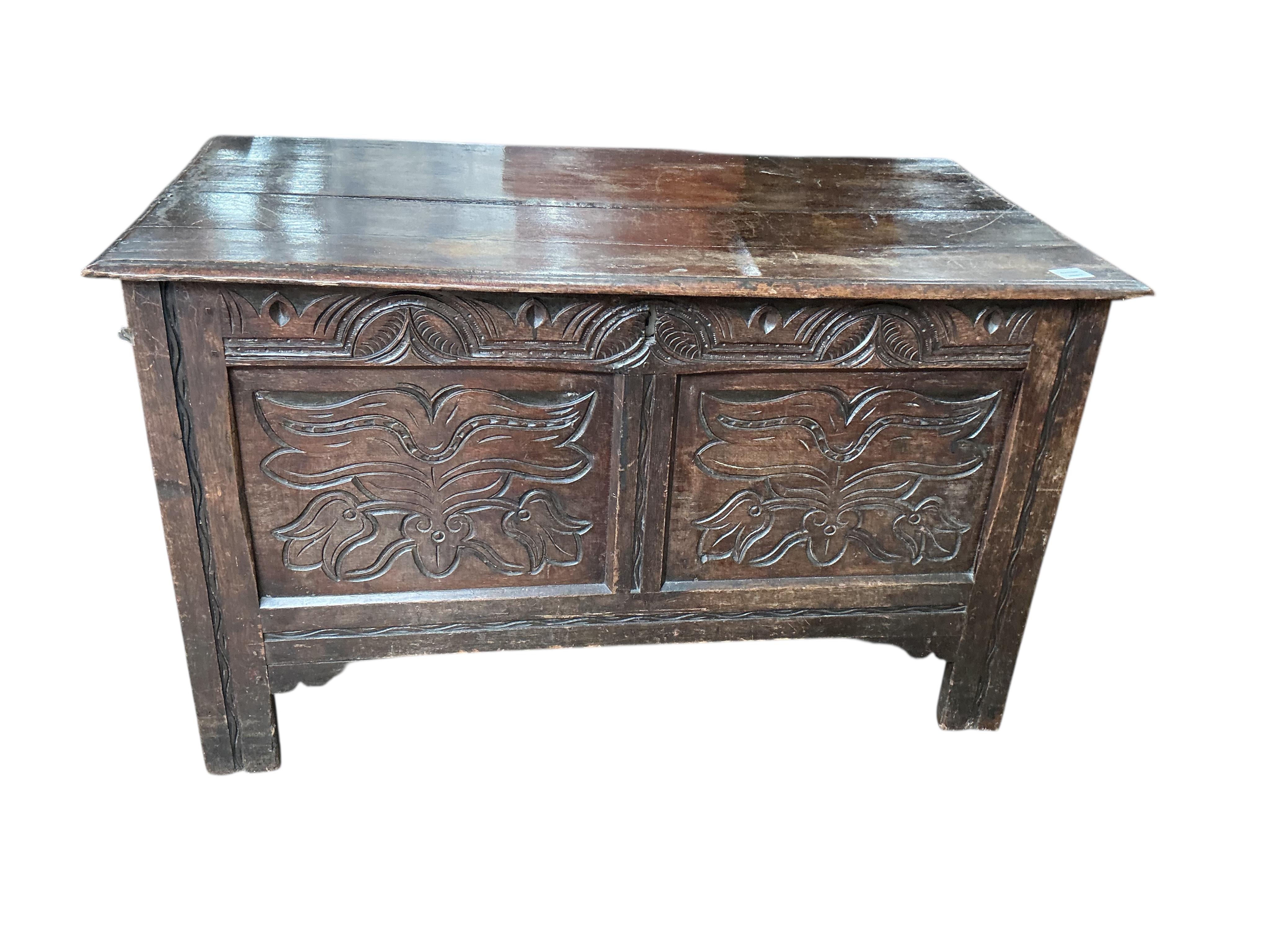 An early 18th century carved oak coffer, width 118cm